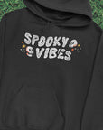 Spooky Vibes Halloween T-Shirt with Skulls on Black Hoodie by Nurtured by Nature Studio