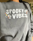 Spooky Vibes Halloween T-Shirt with Skulls on Garment Dyed Grey Crewneck Sweatshirt by Nurtured by Nature Studio