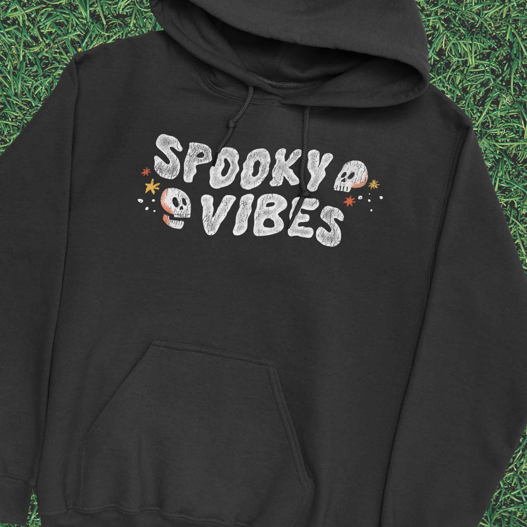 Spooky Vibes Halloween T-Shirt with Skulls on Black Hoodie by Nurtured by Nature Studio